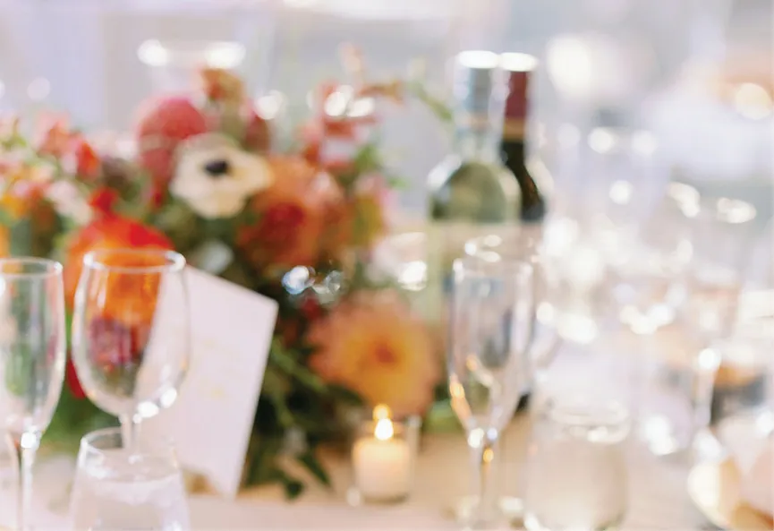 Wedding reception table with floral centerpiece and décor by Event Floral